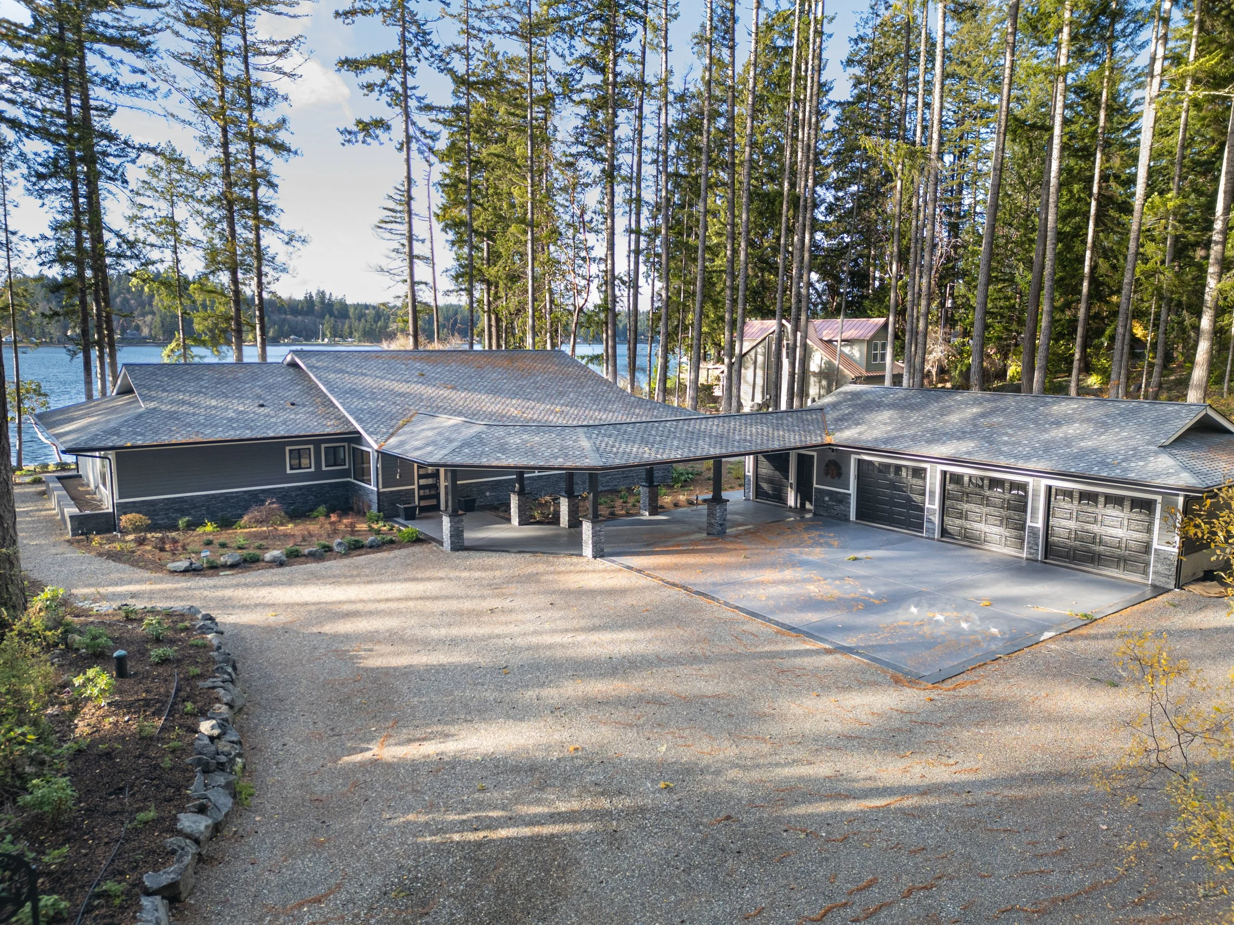 Millers' modern ranch custom home on Harstine Island featuring 4-bay garage and water views - aerial view - FoxHead Construction Mason County