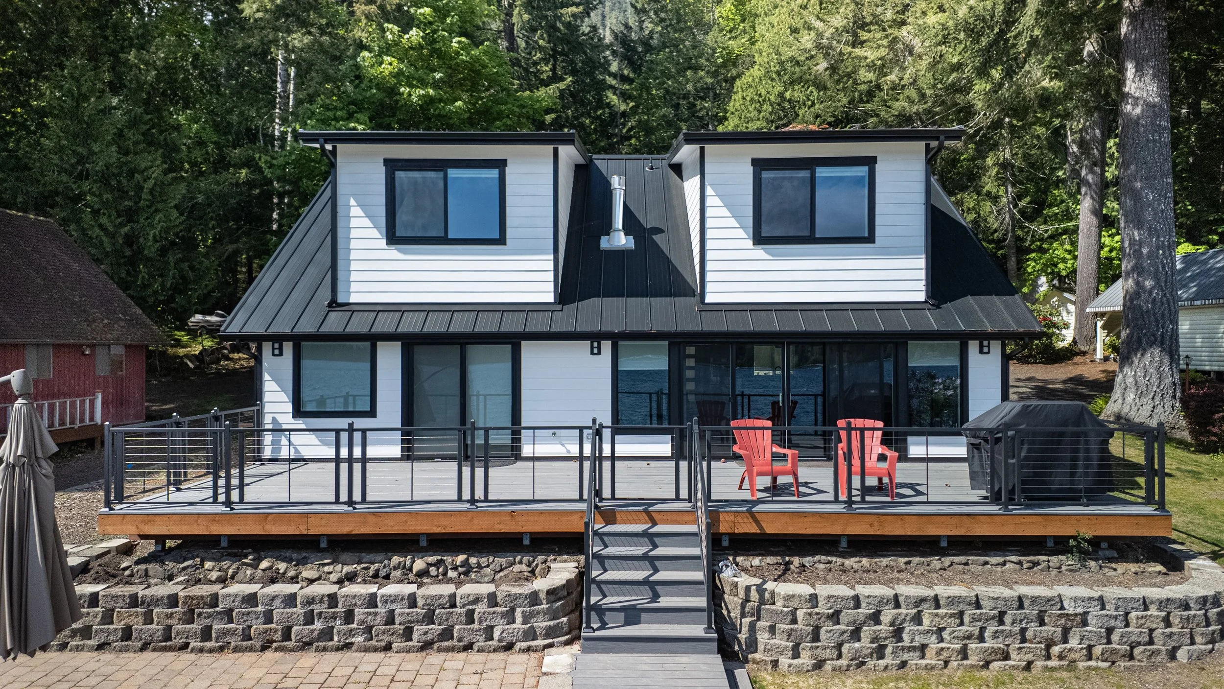 Cain's whole home lake house remodel on Lake Cushman featuring lakefront deck and dormers - FoxHead Construction Mason County