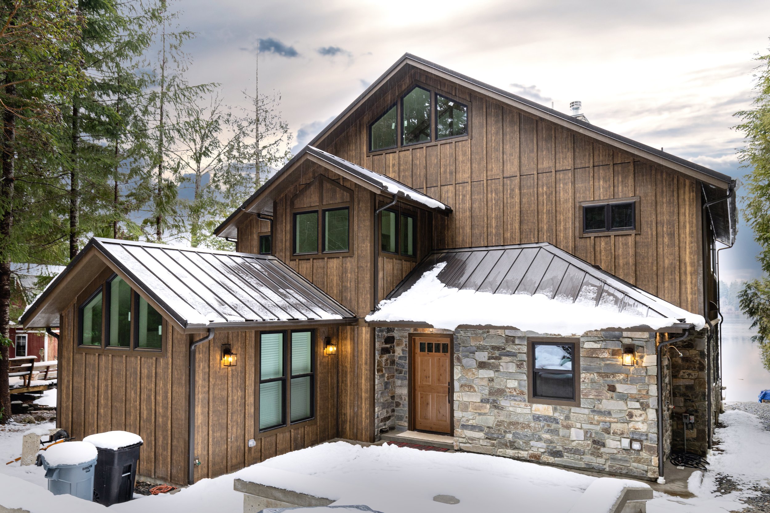 Janhunen's lakefront custom home on Mason Lake featuring rustic cedar exterior with metal roof - FoxHead Construction Mason County