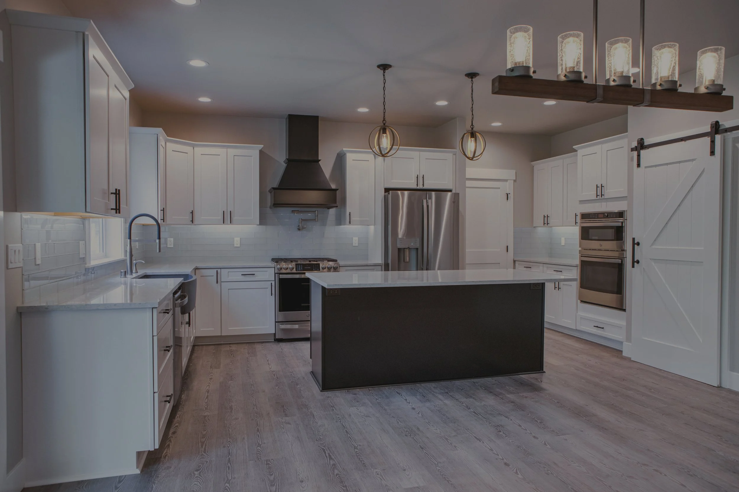 Clark's modern farmhouse custom home in Steamboat Island area featuring white kitchen with large island - FoxHead Construction Thurston County
