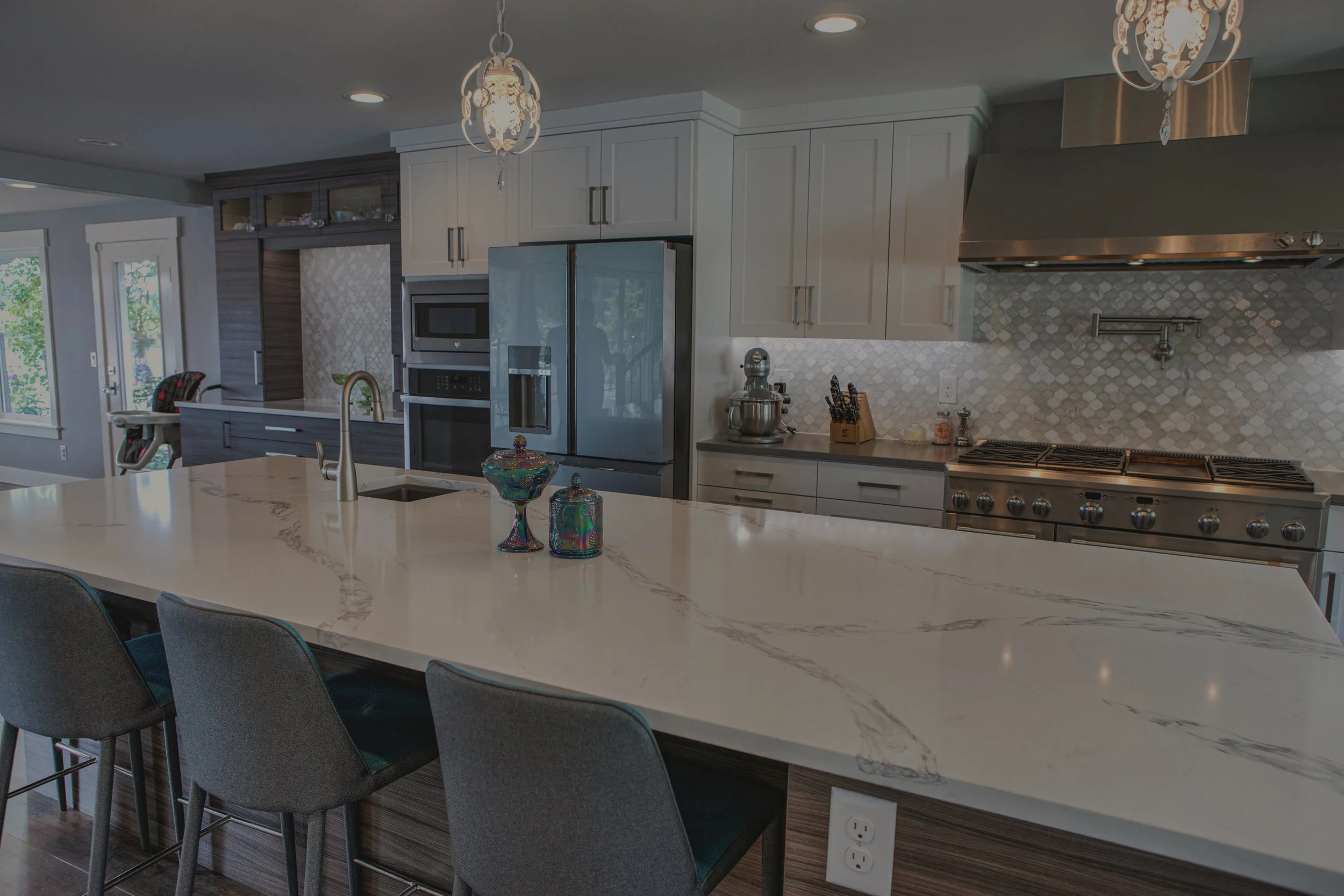 Kelly's modern custom home in Lacey featuring gourmet kitchen with professional range and quartz countertops - FoxHead Construction Thurston County