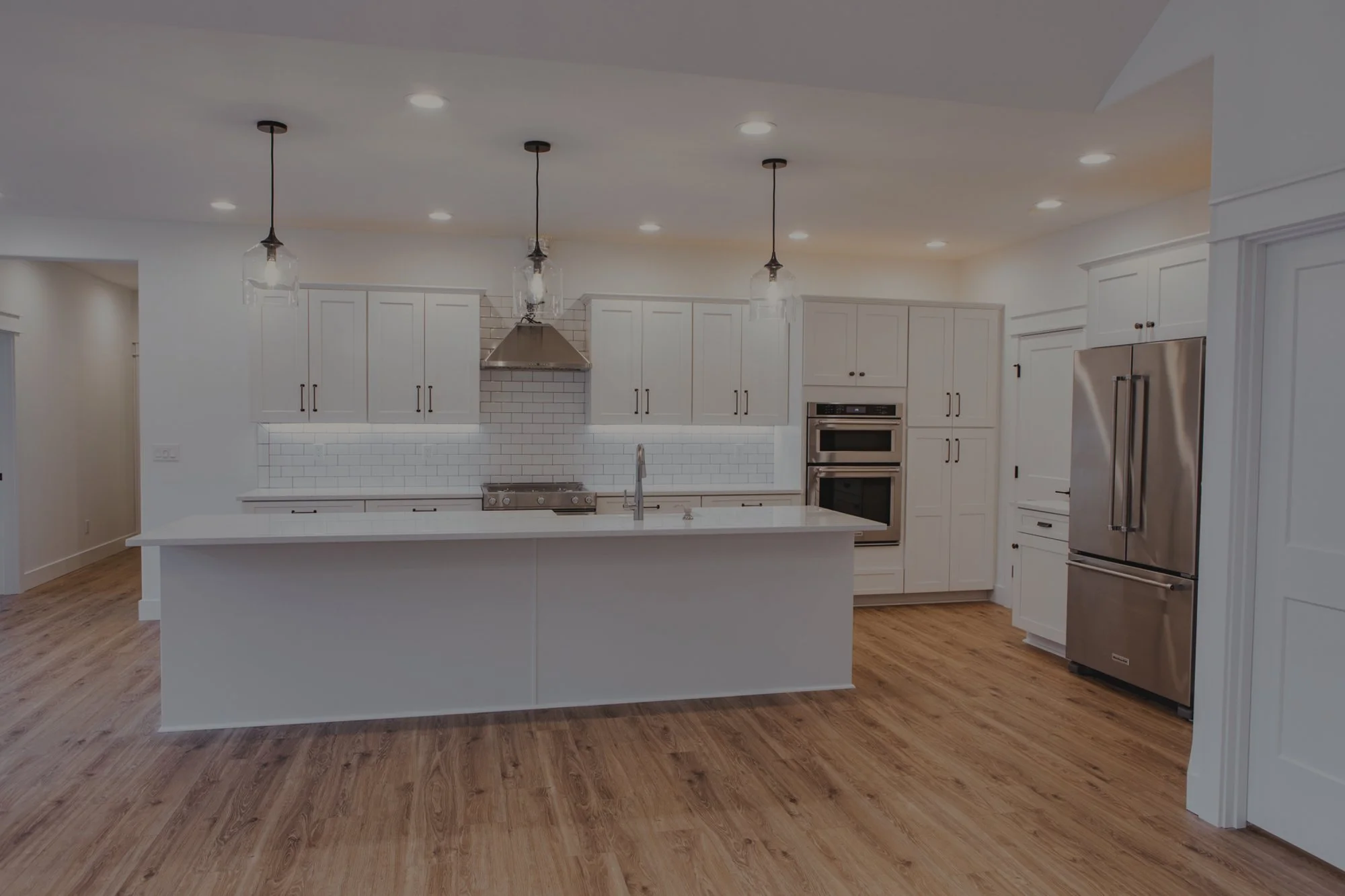 Ben's modern farmhouse custom home in Olympia featuring all-white gourmet kitchen with large island - FoxHead Construction Thurston County