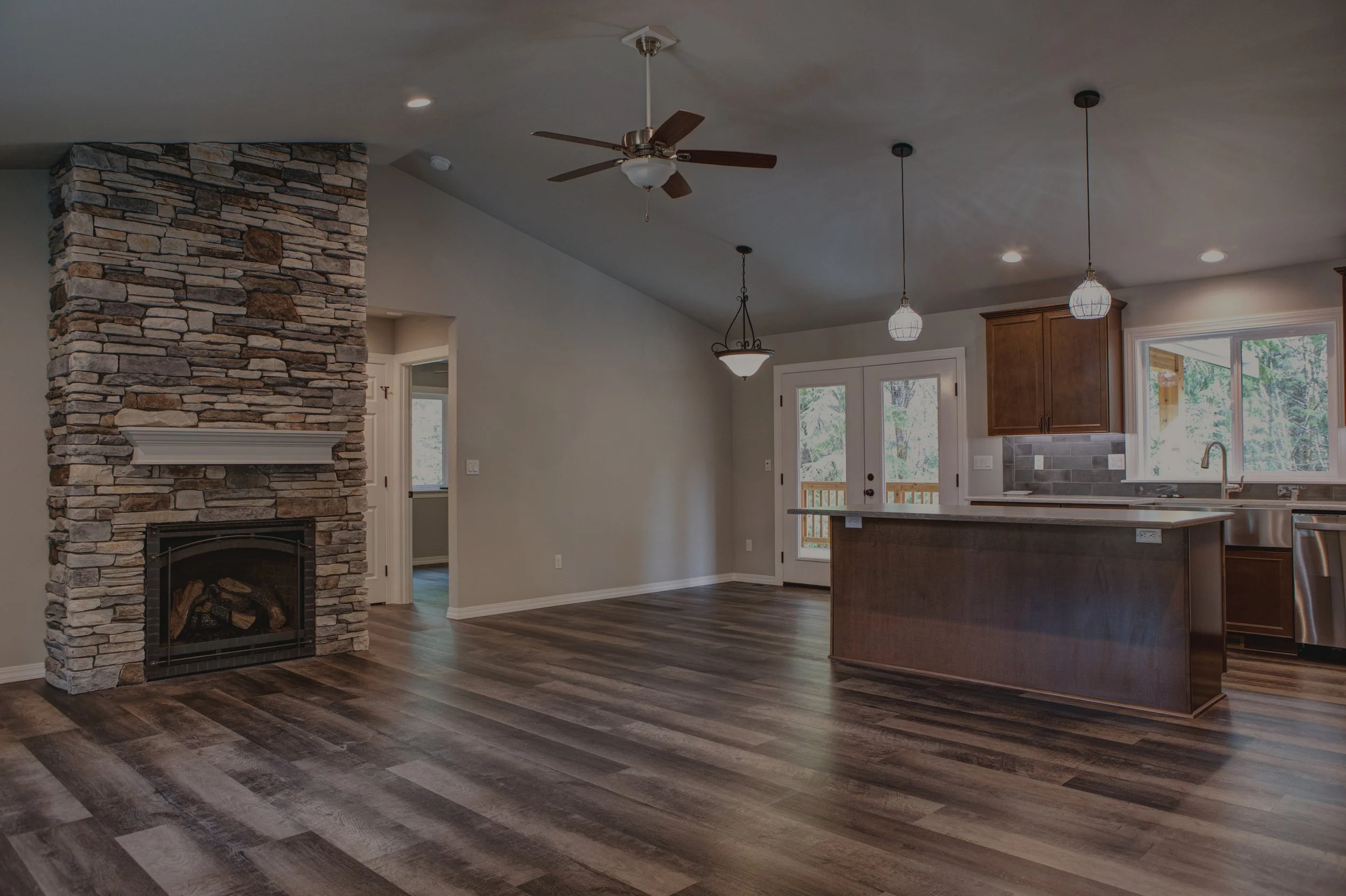 Sharpe's craftsman ranch custom home in Shelton featuring stone fireplace and open concept kitchen - FoxHead Construction Mason County