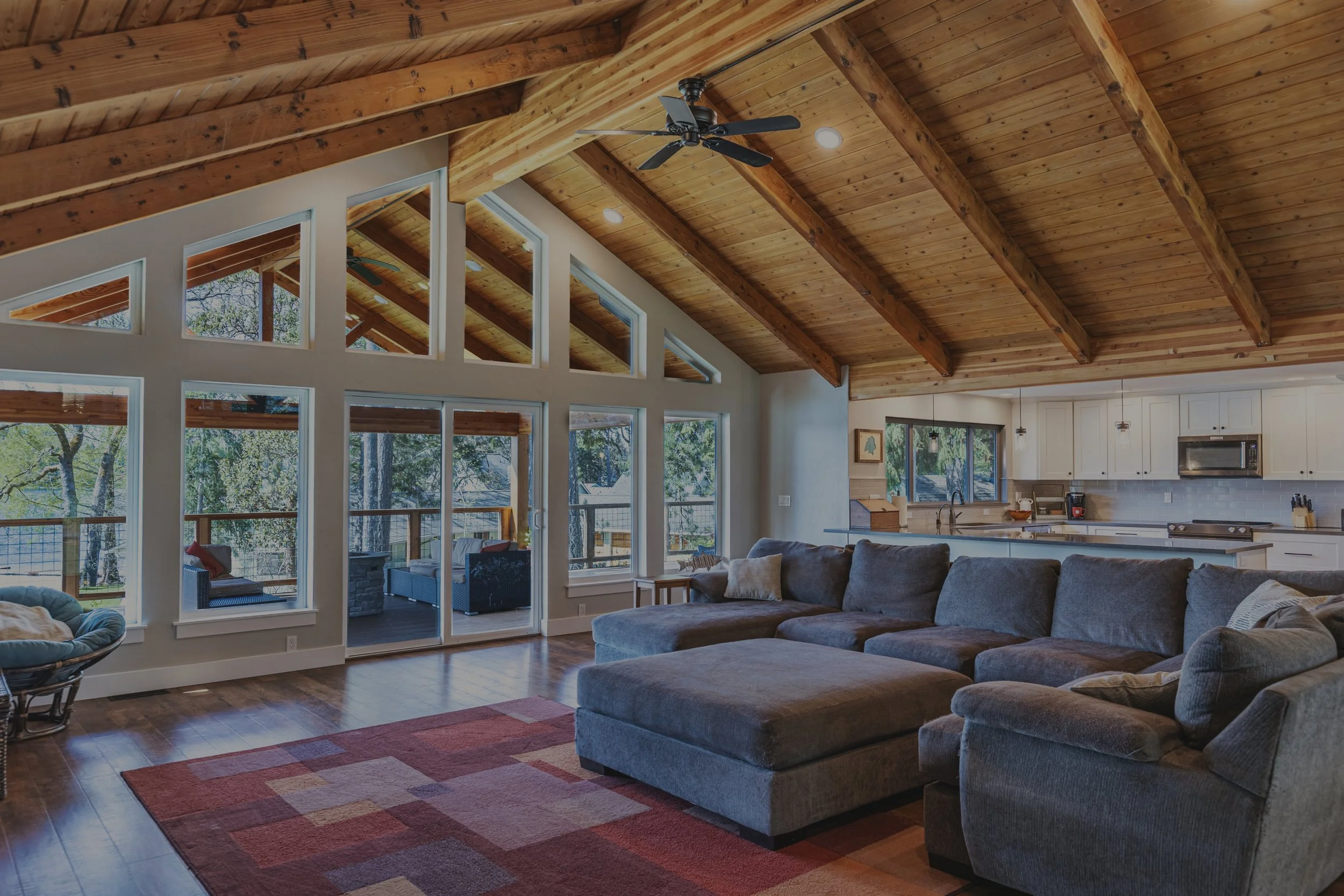 Island Lake whole home remodel featuring exposed timber trusses, vaulted ceilings, and lakefront views - FoxHead Construction Mason County