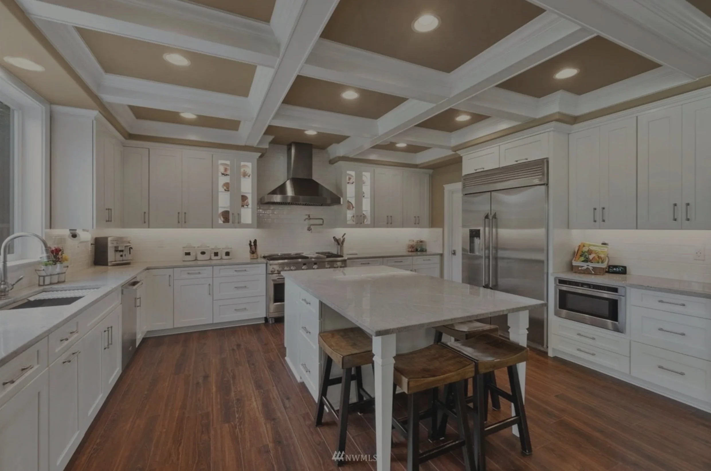 Goodwin's large craftsman custom home in Olympia featuring white kitchen and coffered ceilings - FoxHead Construction Thurston County
