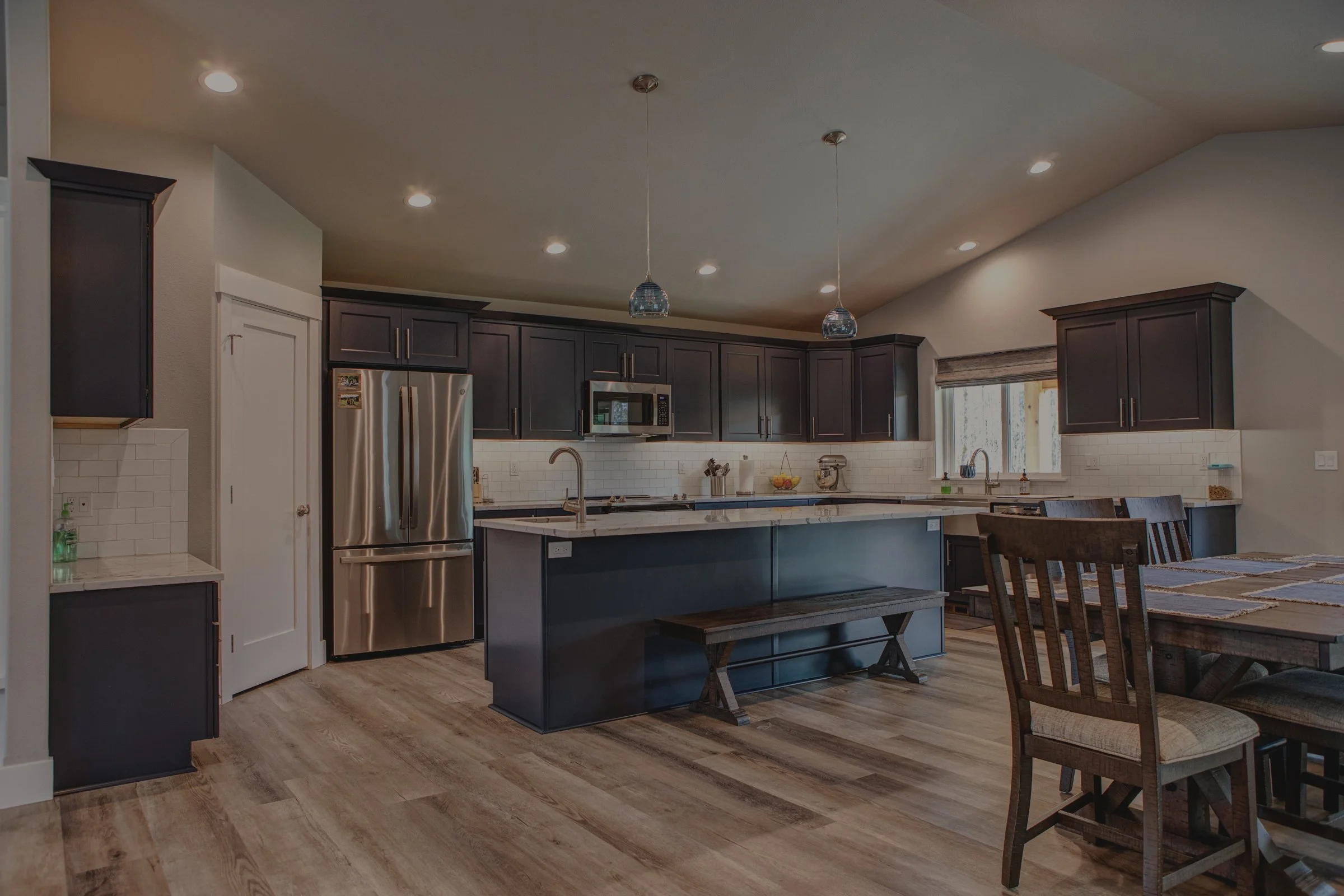 Jim's modern craftsman ranch custom home in Centralia featuring open concept kitchen with large island - FoxHead Construction Lewis County