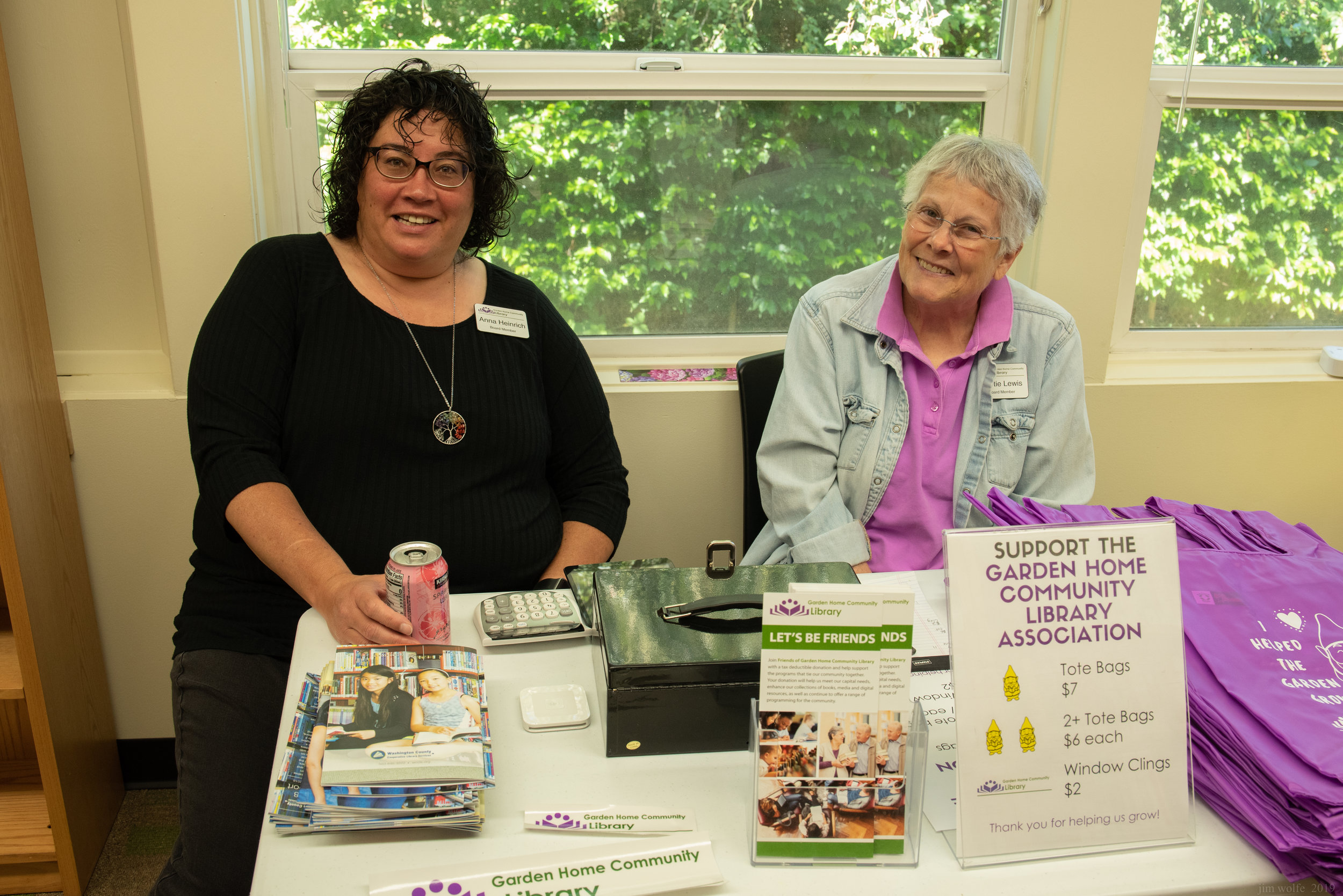  Board Members Anna Heinrich and Martie Lewis selling library swag at the party. 