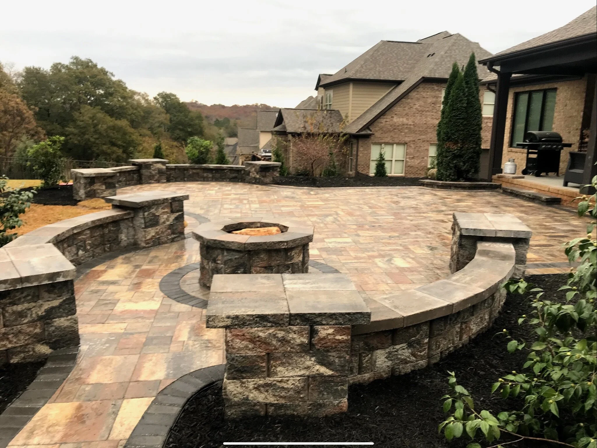 Backyard hardscape and retaining wall installation for outdoor living in Greenville, SC