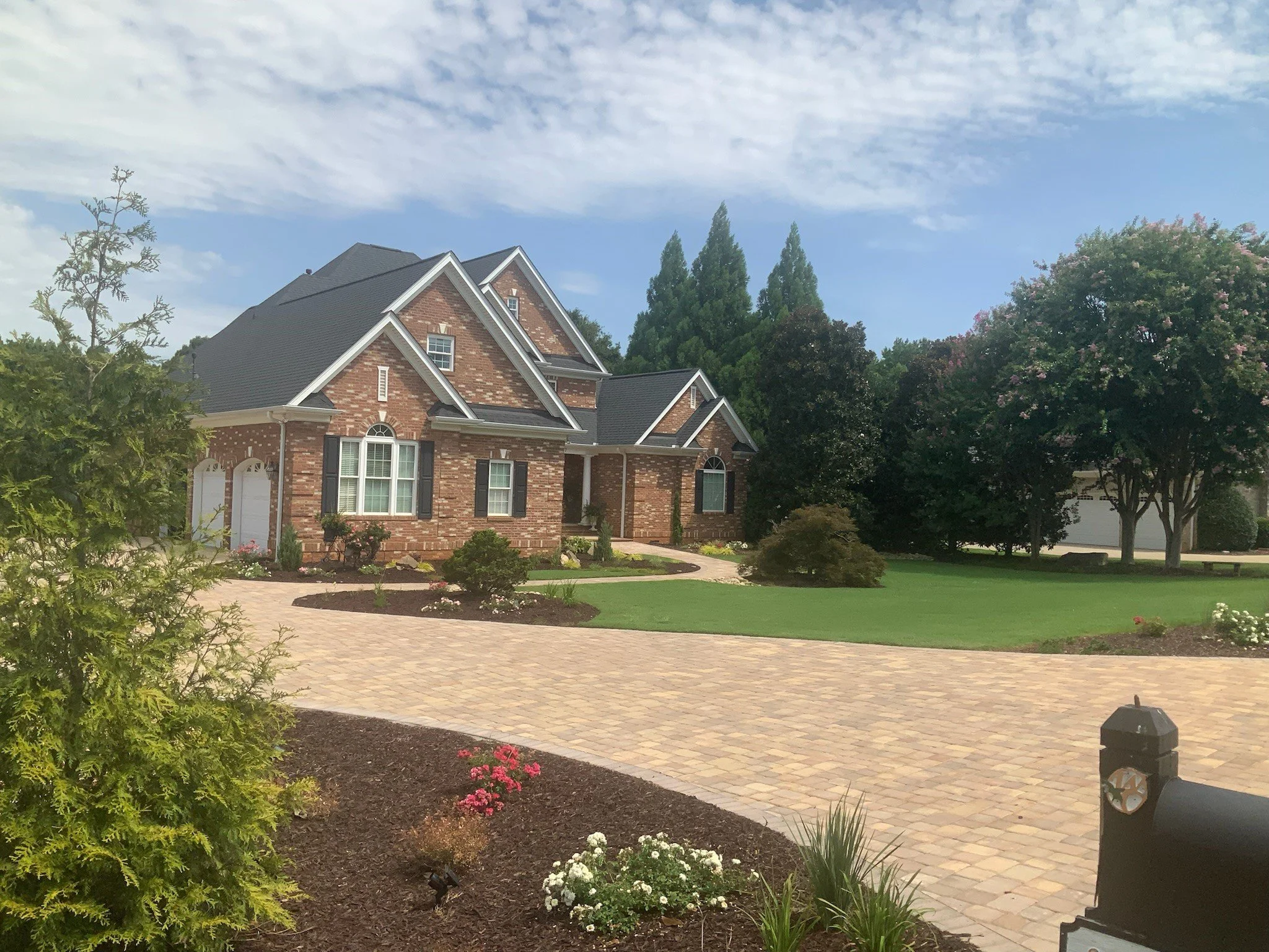 Custom paver driveway with sweeping curve and landscaping in Greer, SC