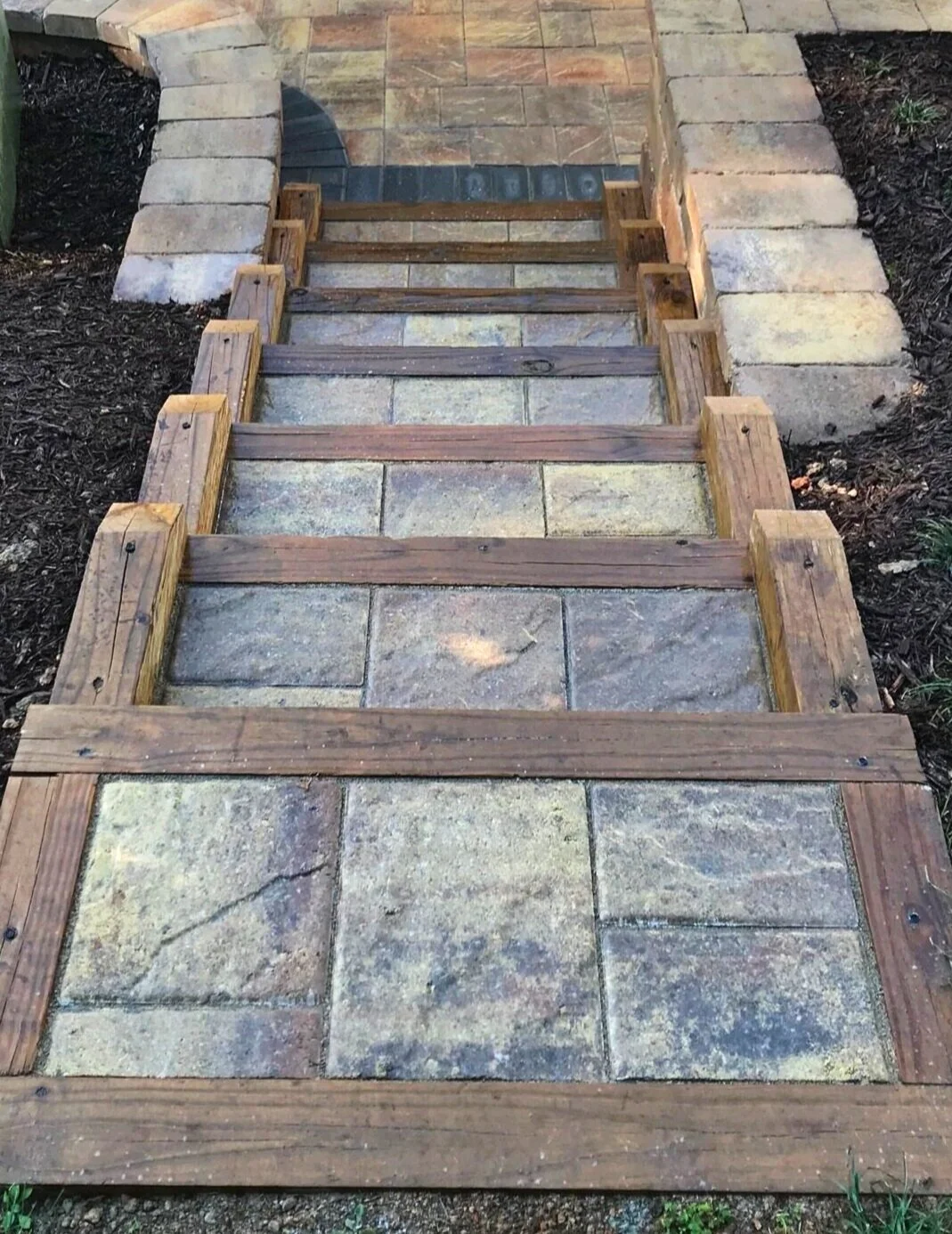 Spacious backyard paver path with fire pit and seating area in Greer, SC