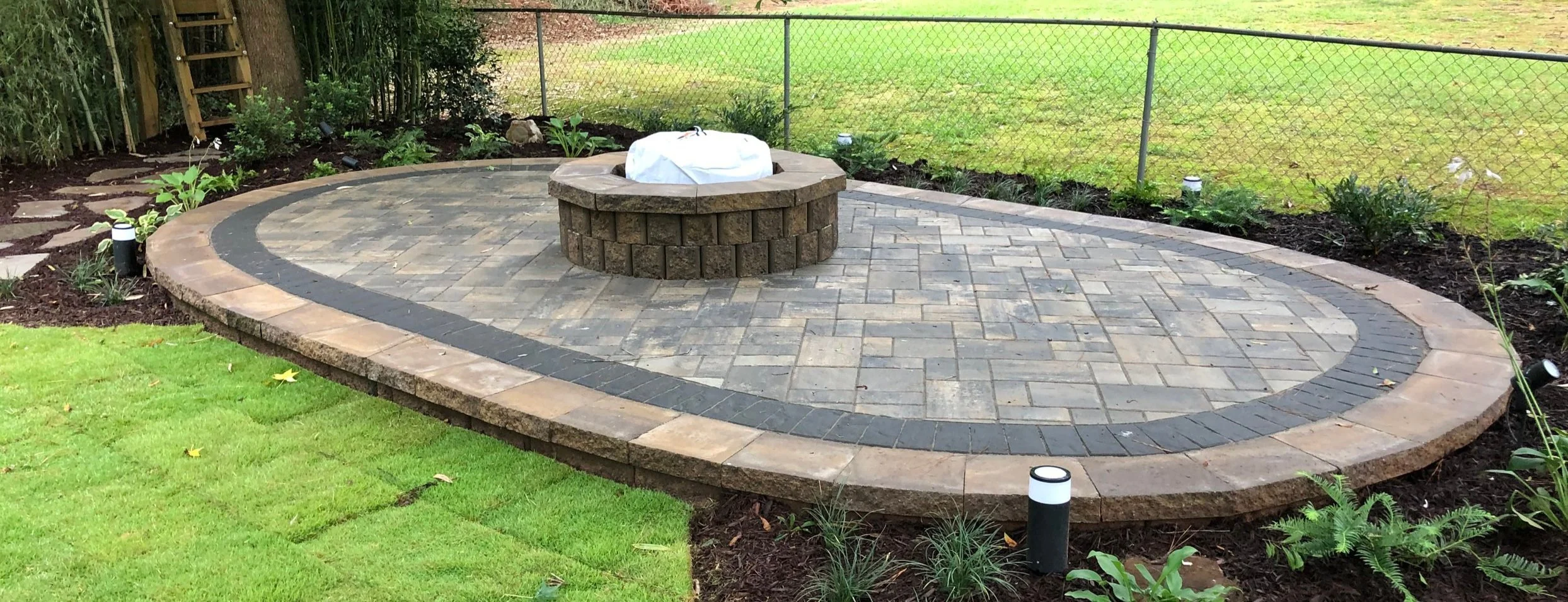 Fire pit built into circular paver patio in Easley, SC