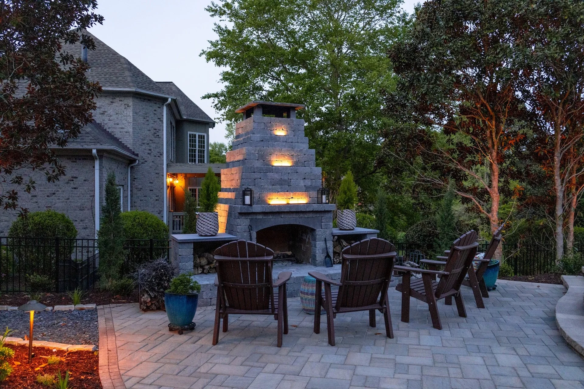 Stone fireplace and outdoor lighting at night