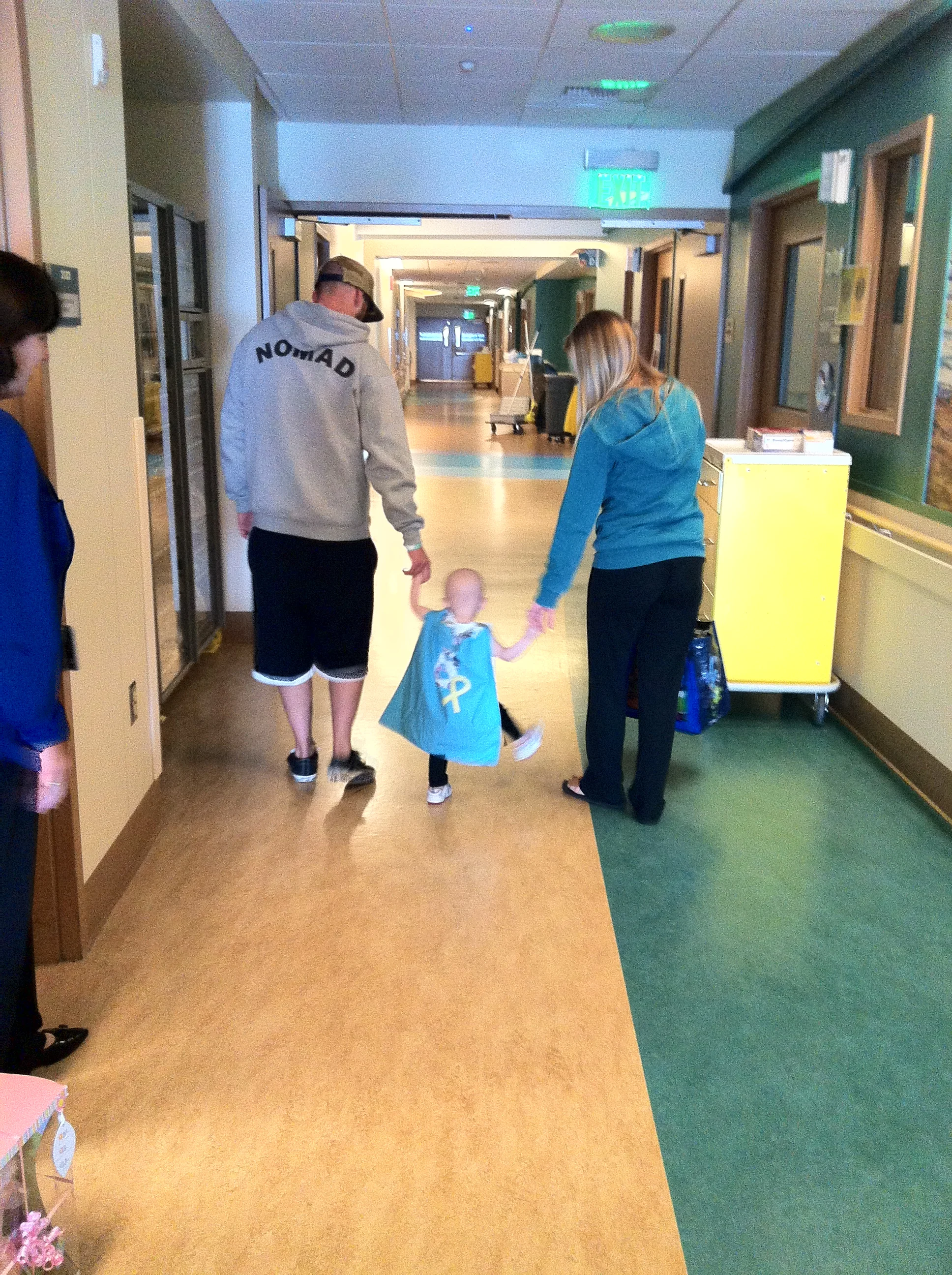Brixton, happily walking the hospital halls with dad and mom in hand