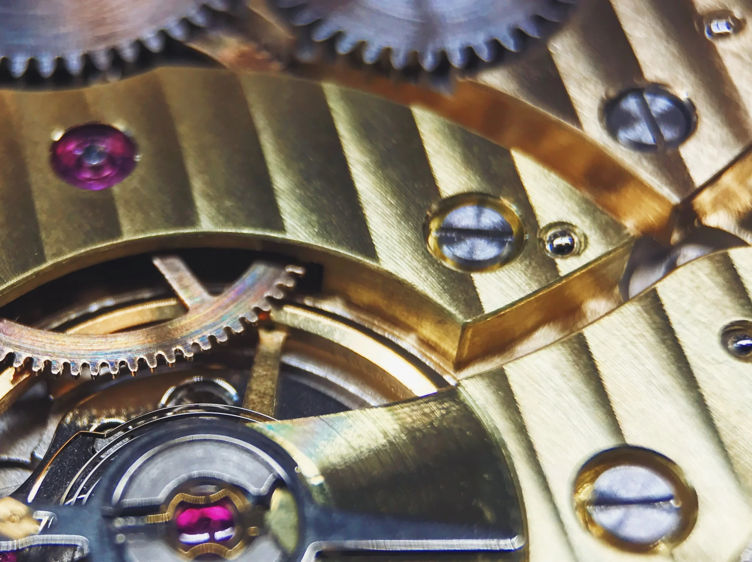 The brasses we use glimmer with a rainbow sheen at certain angles, depending on how they're cut—you can see it on the center wheel and pointer recess perfectly in this photo.