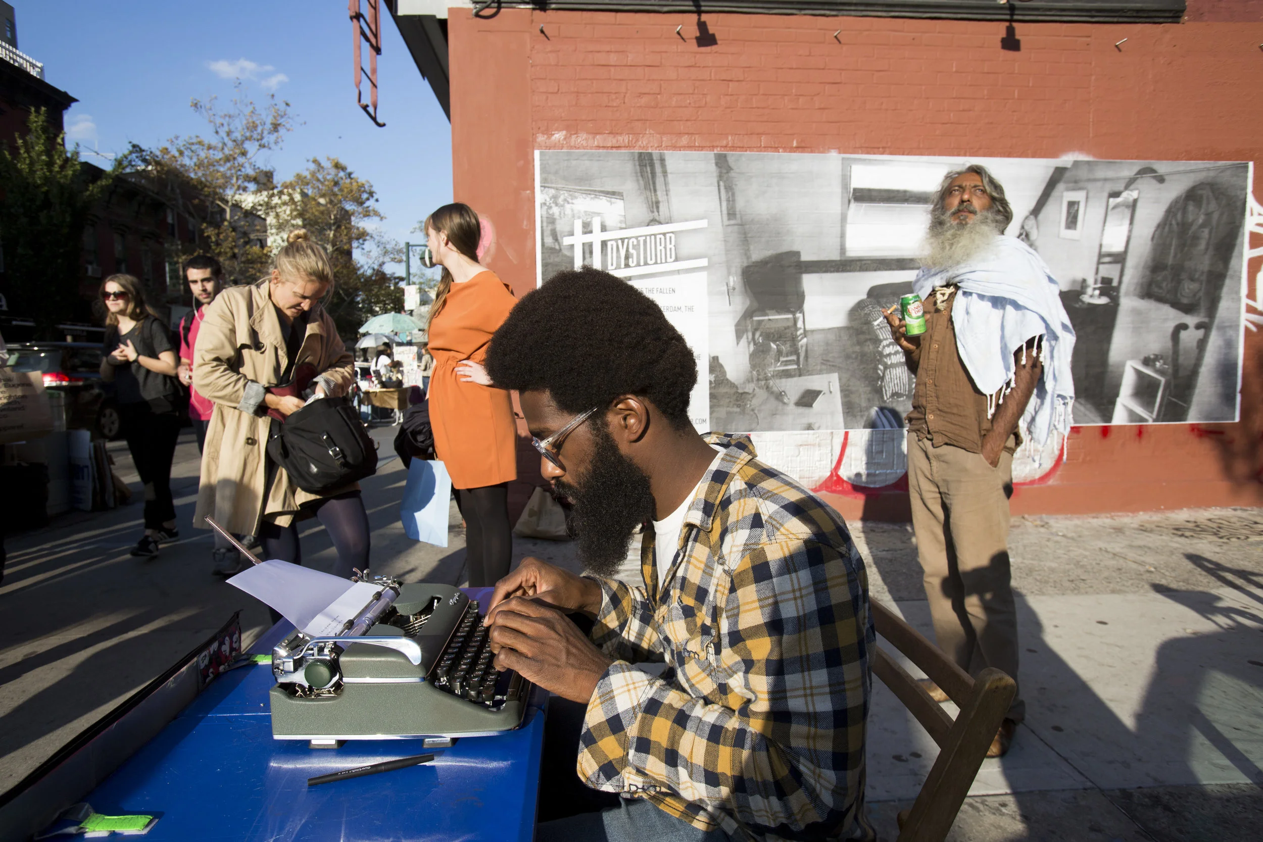 Passersby in Brooklyn, New York in front of one of Dysturb's photographs.