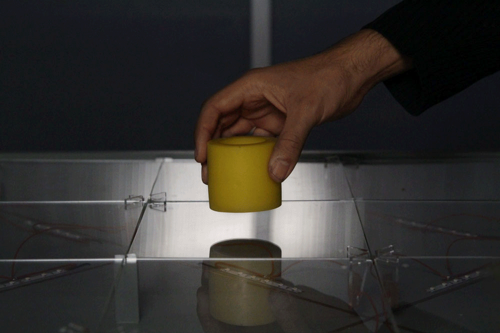 How it works. Assemblage: yellow rubber sleeve, prototyping foam, white casting resin;