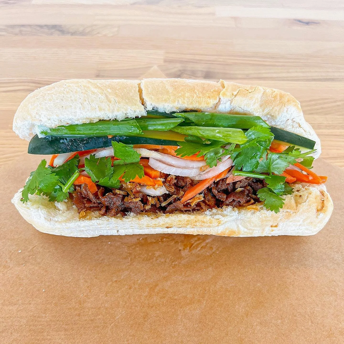 Showing traditional bahn mi sandwhich made in Bellevue by Bahn Mi Shop, known for composting