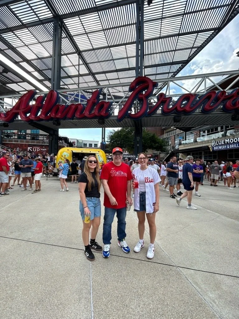 Costa Lab attends the Phillies vs. Braves game at Truist Park. Vinny displays his cognitive dissonance by wearing a Mets cap. 