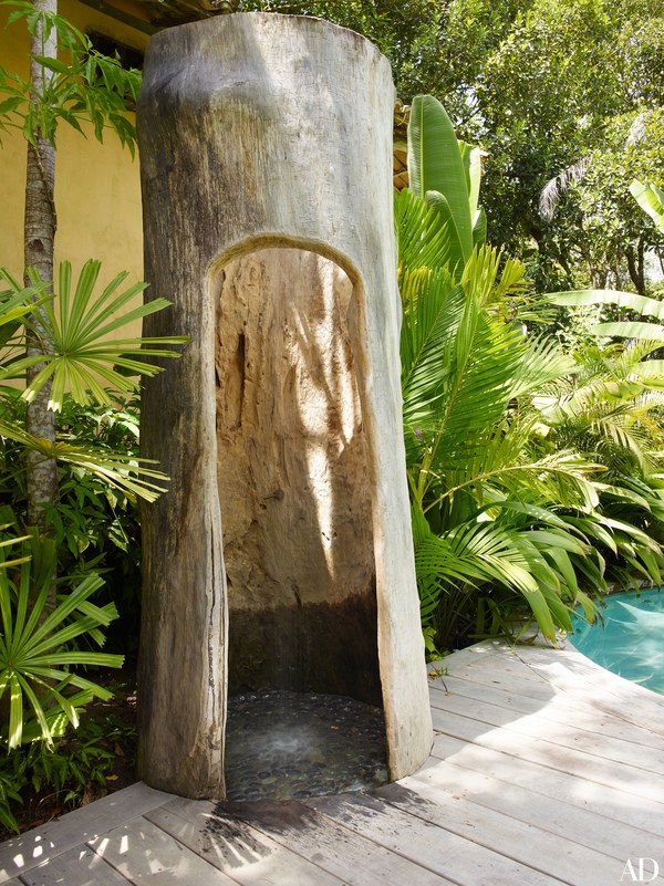 Wilbert Das used a hollowed out tree trunk to make an outdoor shower.