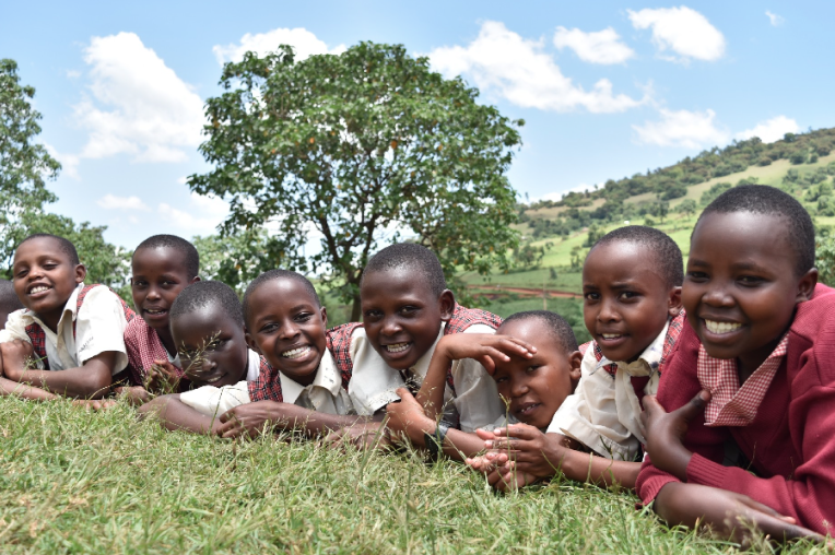 Girls lounge outside on a beautiful day in Enoosaen