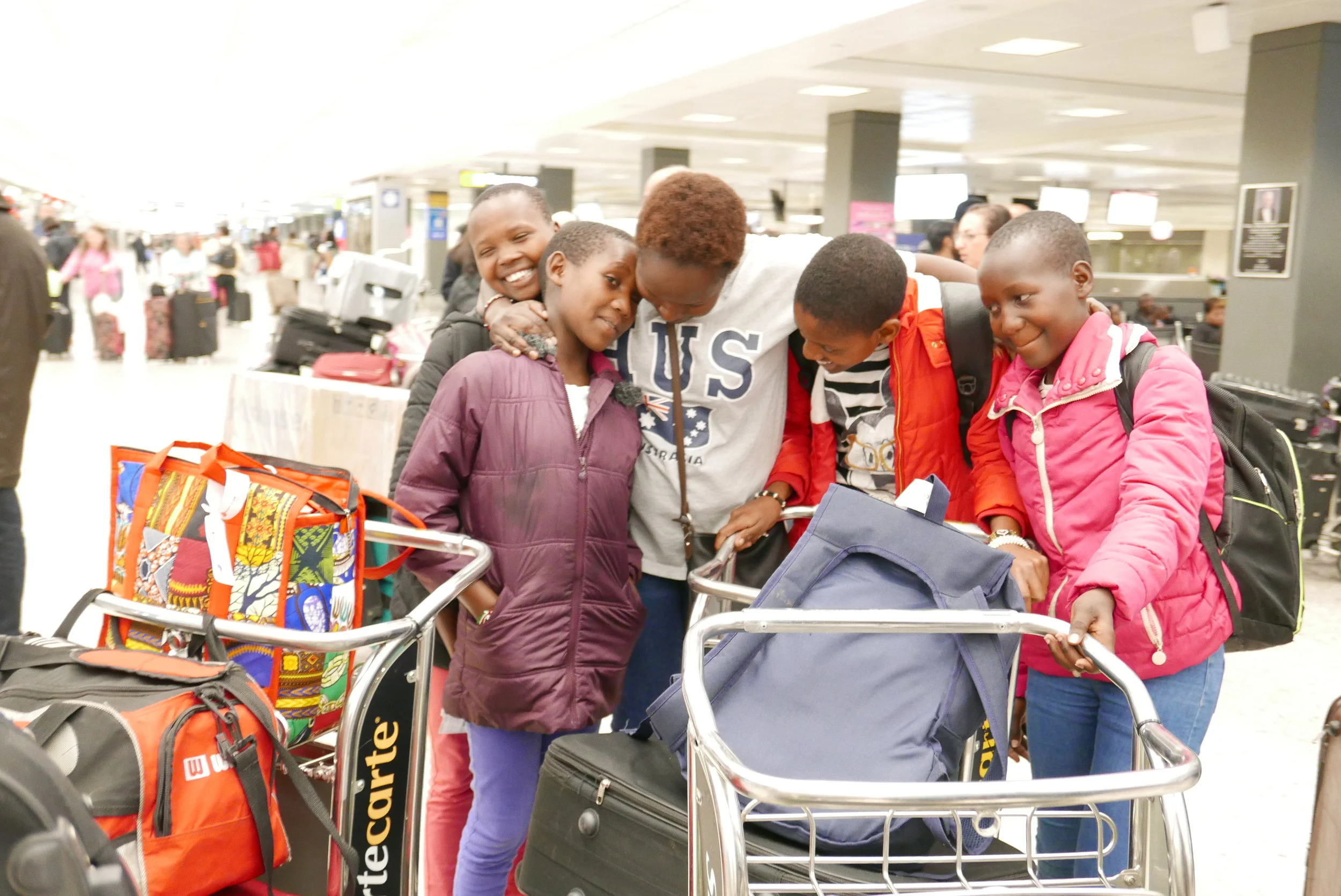 The girls are reunited with Kakenya at the Dulles International Airport in Virginia.