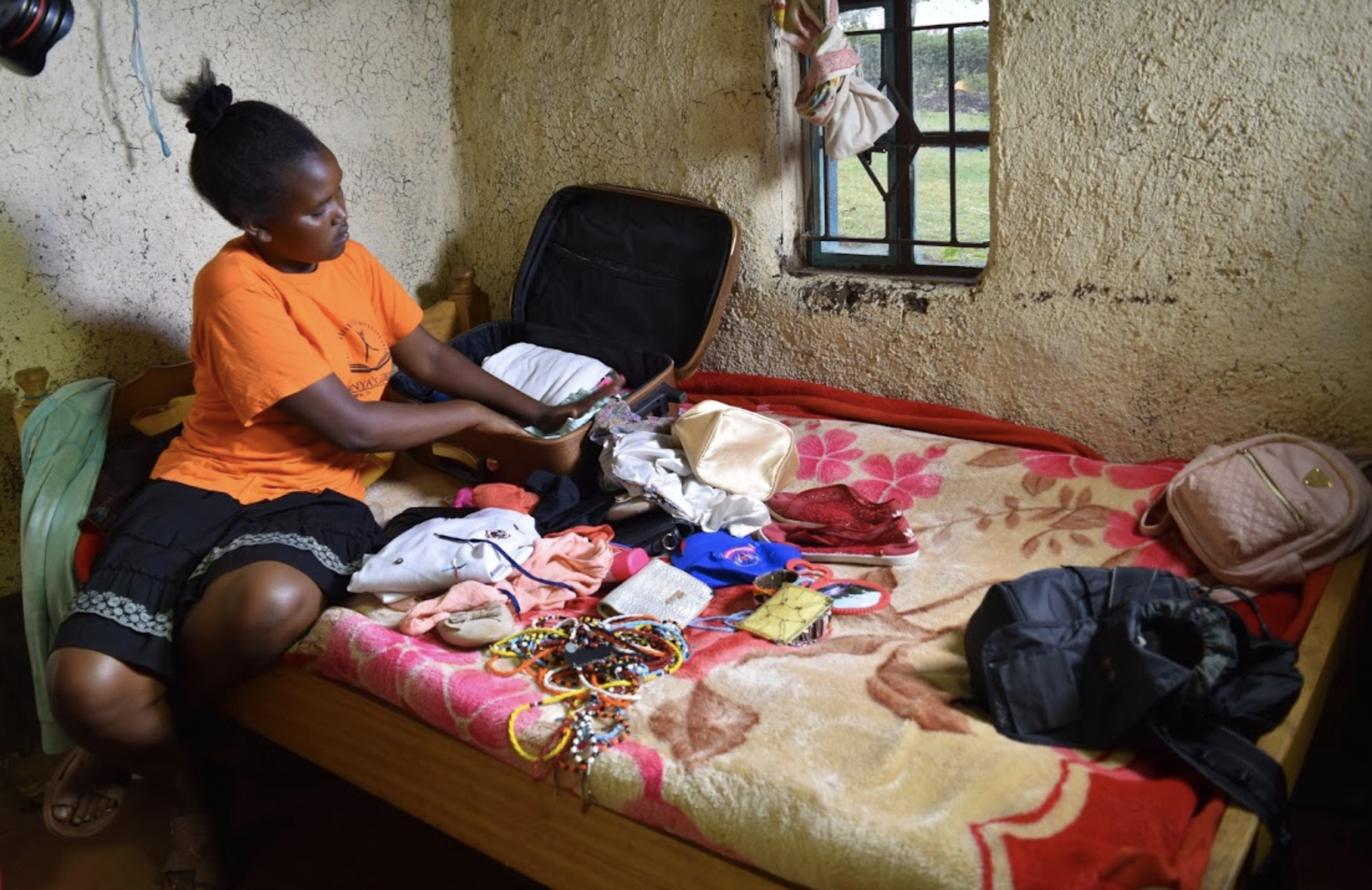 Linet packs at her family home ahead of the trip