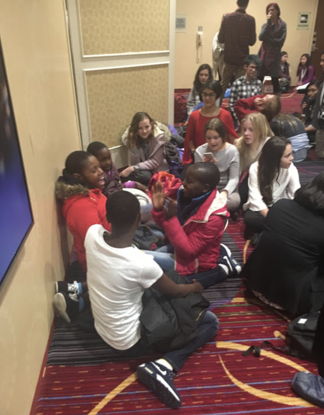 The girls teach their new friends a fun game from KCE