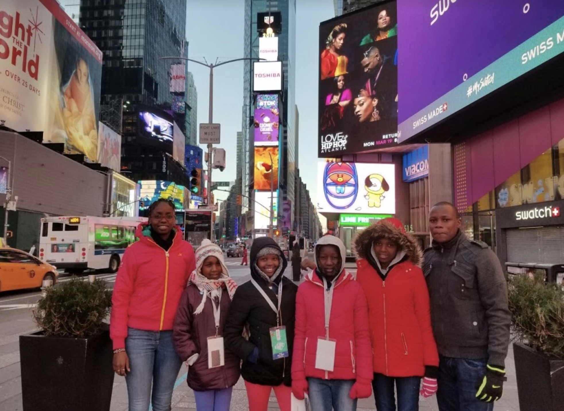 The visitors pause for a picture in NYC's Time Square