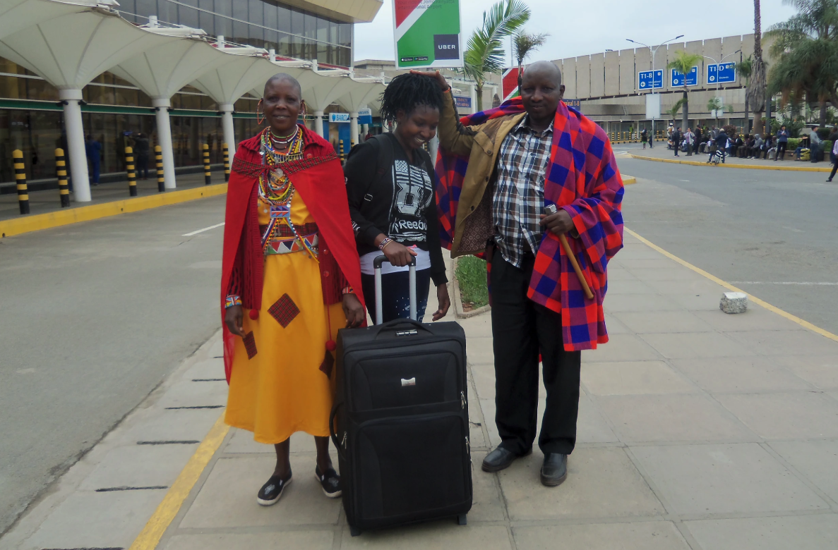 Magdalene says goodbye to her parents. Her father gives her a traditional Maasai blessing by placing his hand on her head.