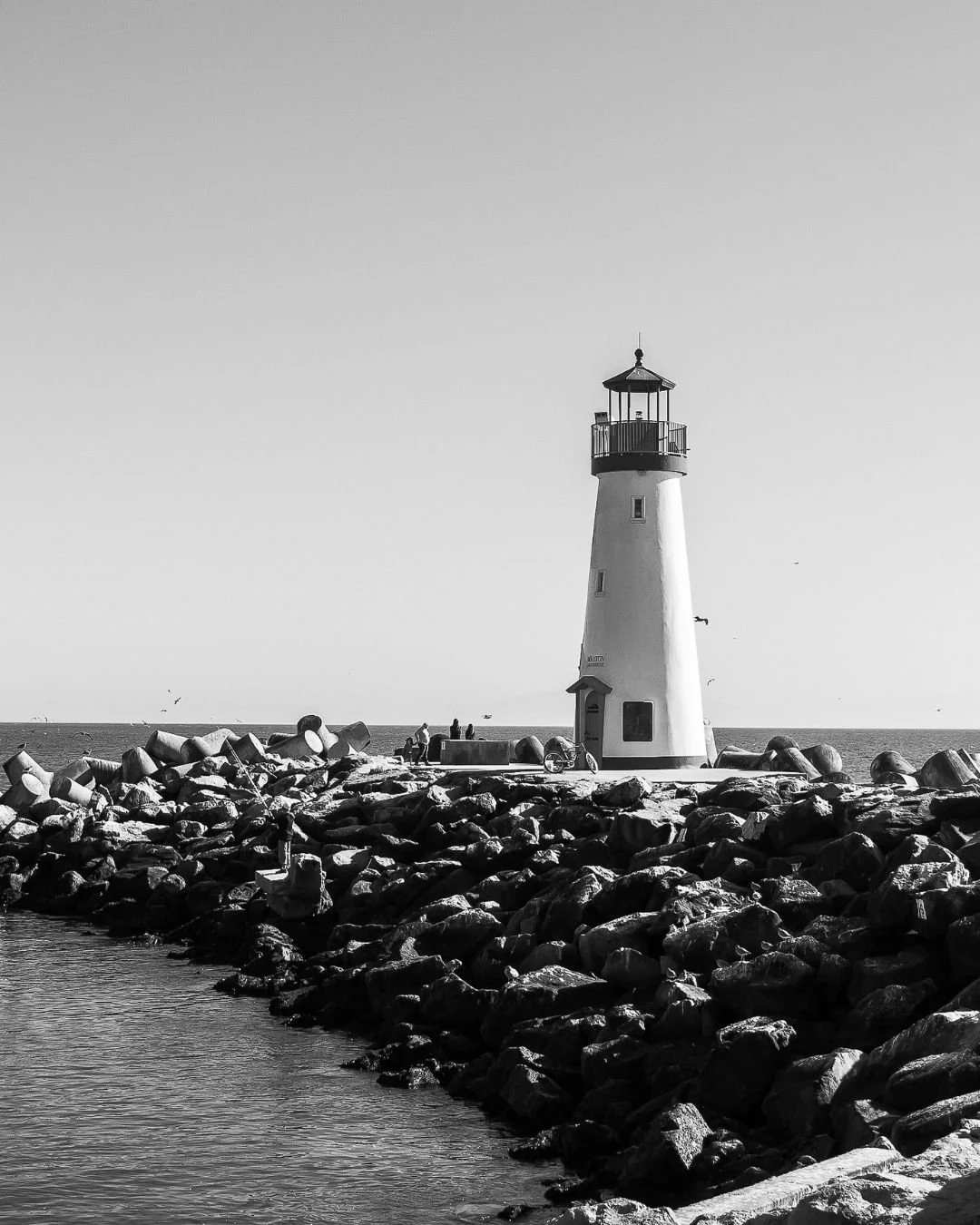 a black and white lighthouse over calm waters for ritual health acupuncture in berkeley california