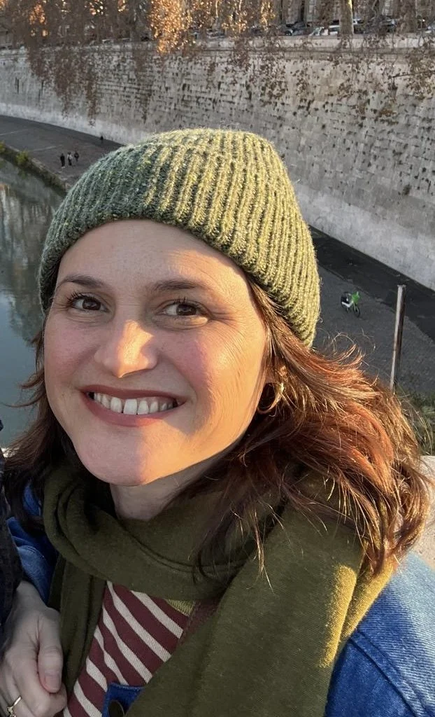 Tara Bianca Rado of Durham Acupuncture smiles at the camera in green scarf on a sunny afternoon. She is co-teacher of yangsheng Art of Living class at Ritual Health Acupuncture in Berkeley