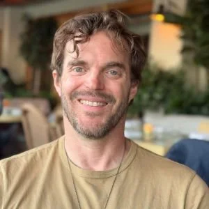 Ritual Health Acupuncture in Berkeley, CA's Adam Okerblom smiles in a cafe setting