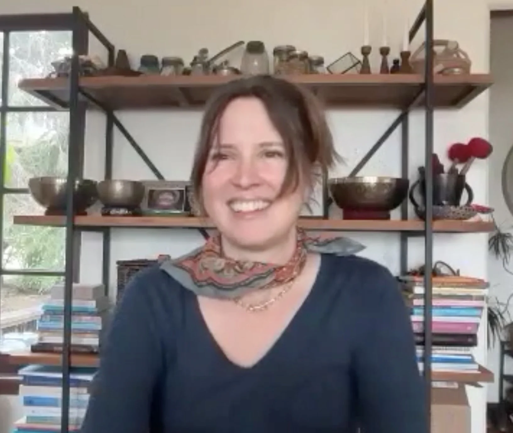 Berkeley acupuncturist for Ritual Health Anne Shelton Crute lecturing about the 24 solar terms and yangsheng lifestyle and wellness sitting in front of a bookcase class