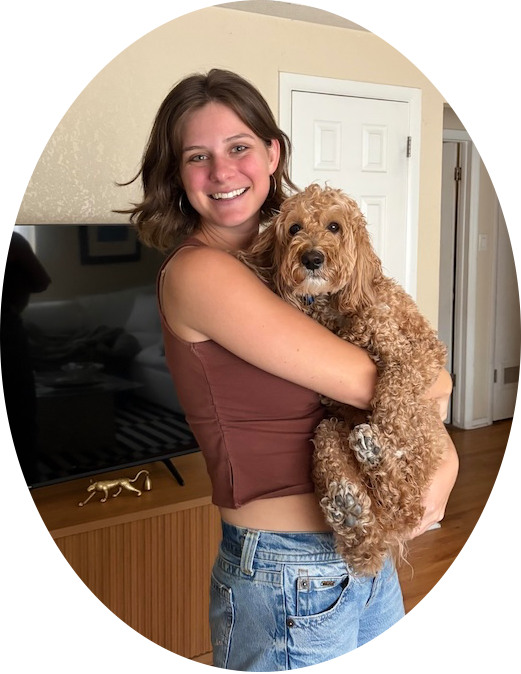 Denver Pro Pet Sitting team member happily holding a curly doodle dog