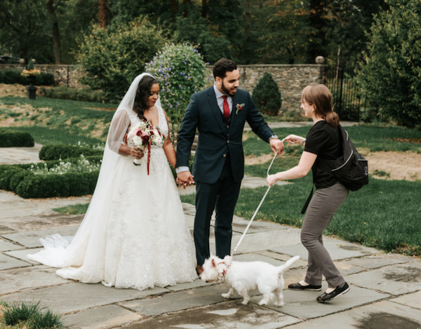 Denver pet sitting for weddings with dog handler assisting couple and their dog at outdoor venue