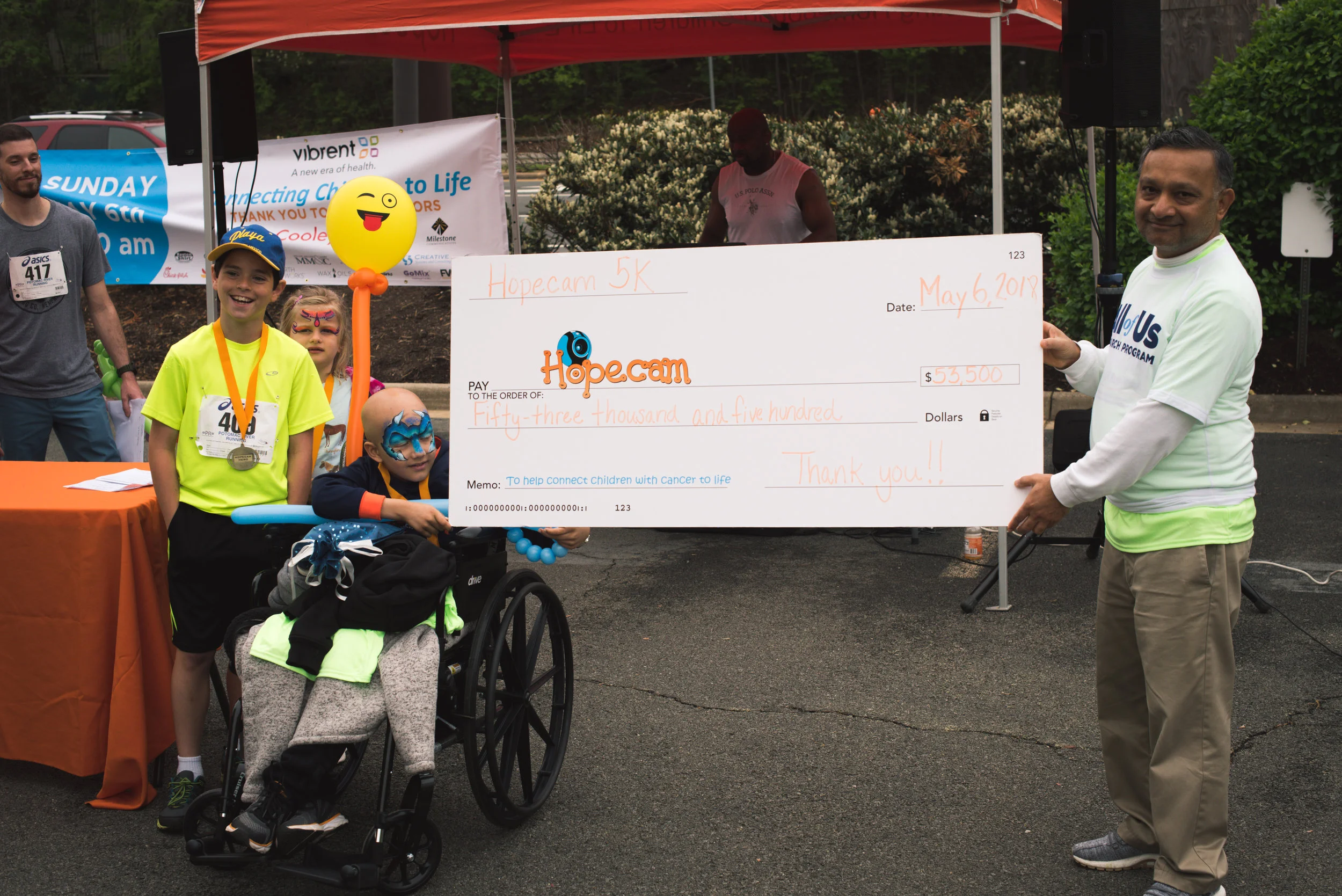 Thank you to our Title Sponsor Vibrent Health , the founder & CEO of Vibrent Health Praduman Jain is holding the check with our Honored Hopecam child Fletcher.