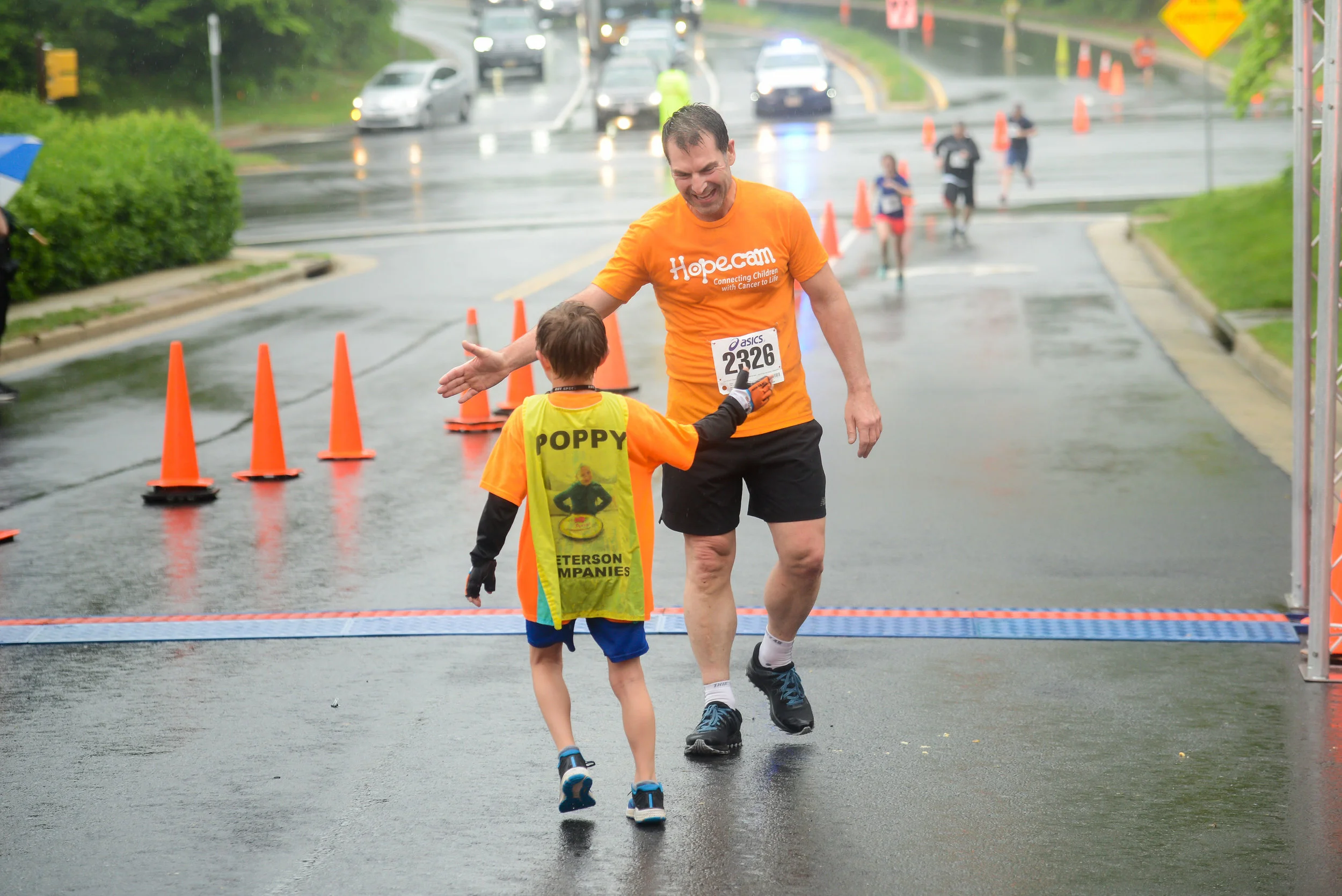 Matteo welcoming Len Forkas across the finish line. Matteo is running 100 miles to help connect more children with cancer! Visit Matteo Runs to learn more.