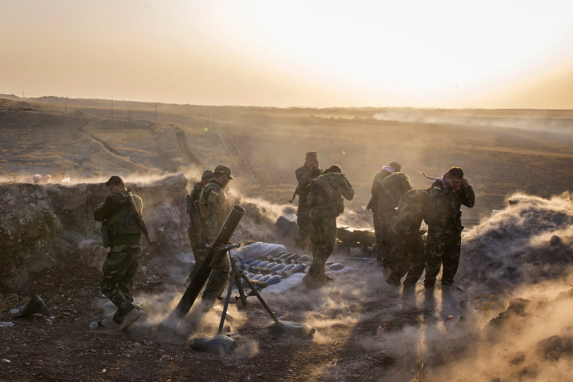  A Peshmerga mortar team fires at Islamic State positions in support of a Kurdish assault. 