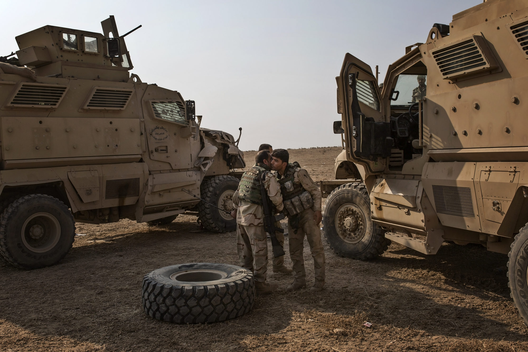  The drivers of two Peshmerga armoured vehicles kiss each other after both vehicles were hit by improvised explosive devices. 