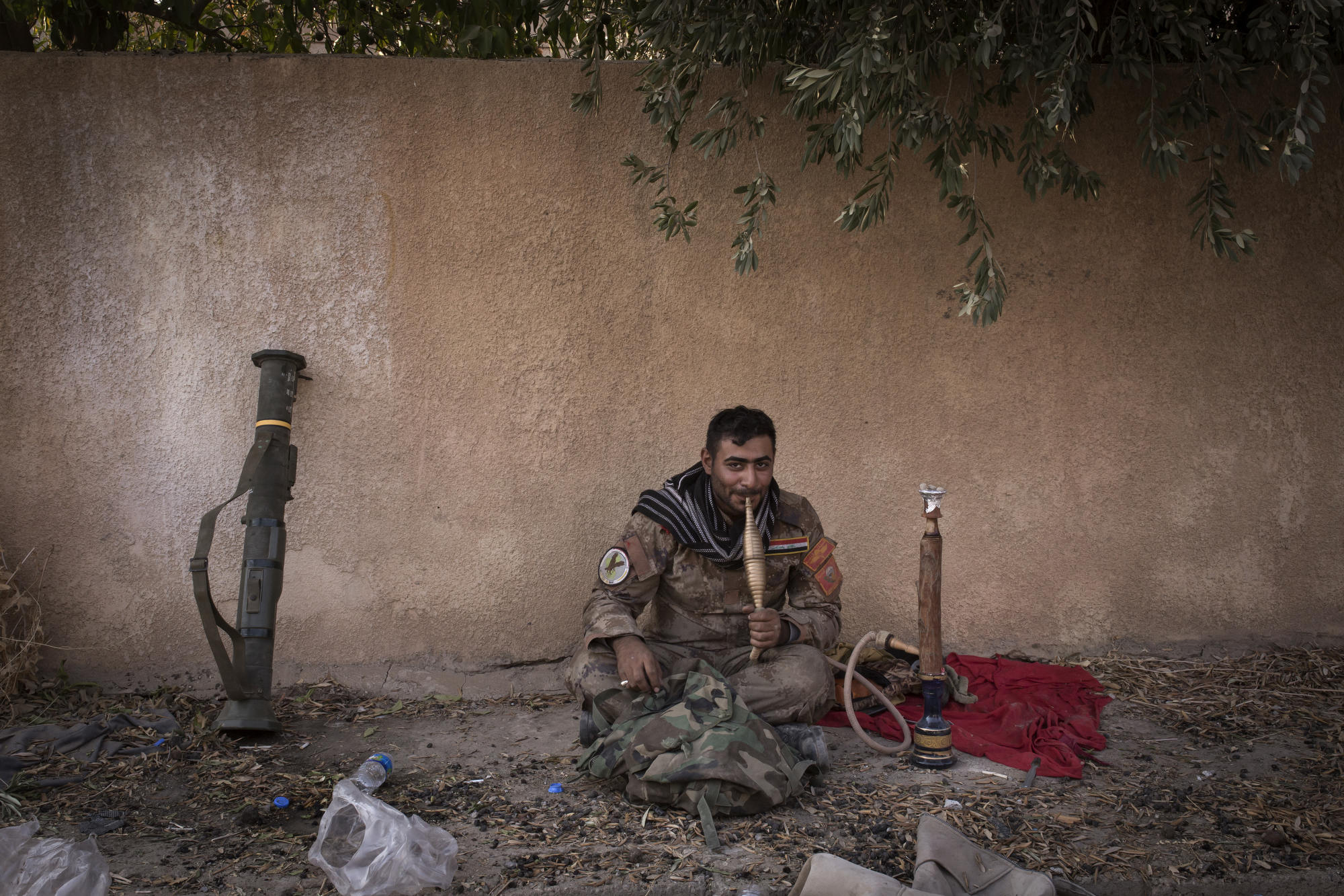  An Iraqi special forces soldier smokes a water pipe in the town of Bartella. 