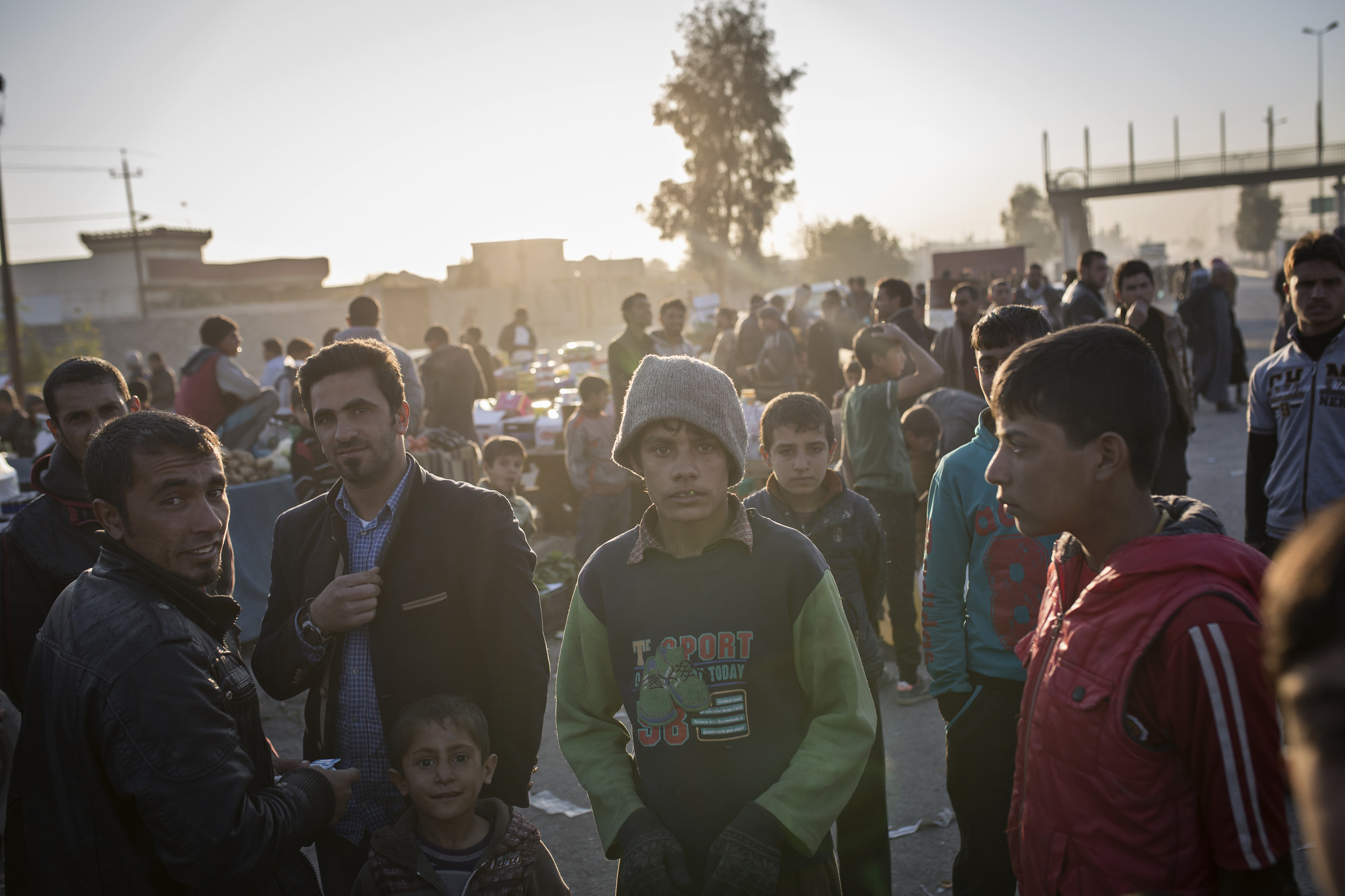  People gather in a recently liberated market in the suburbs of Mosul. 