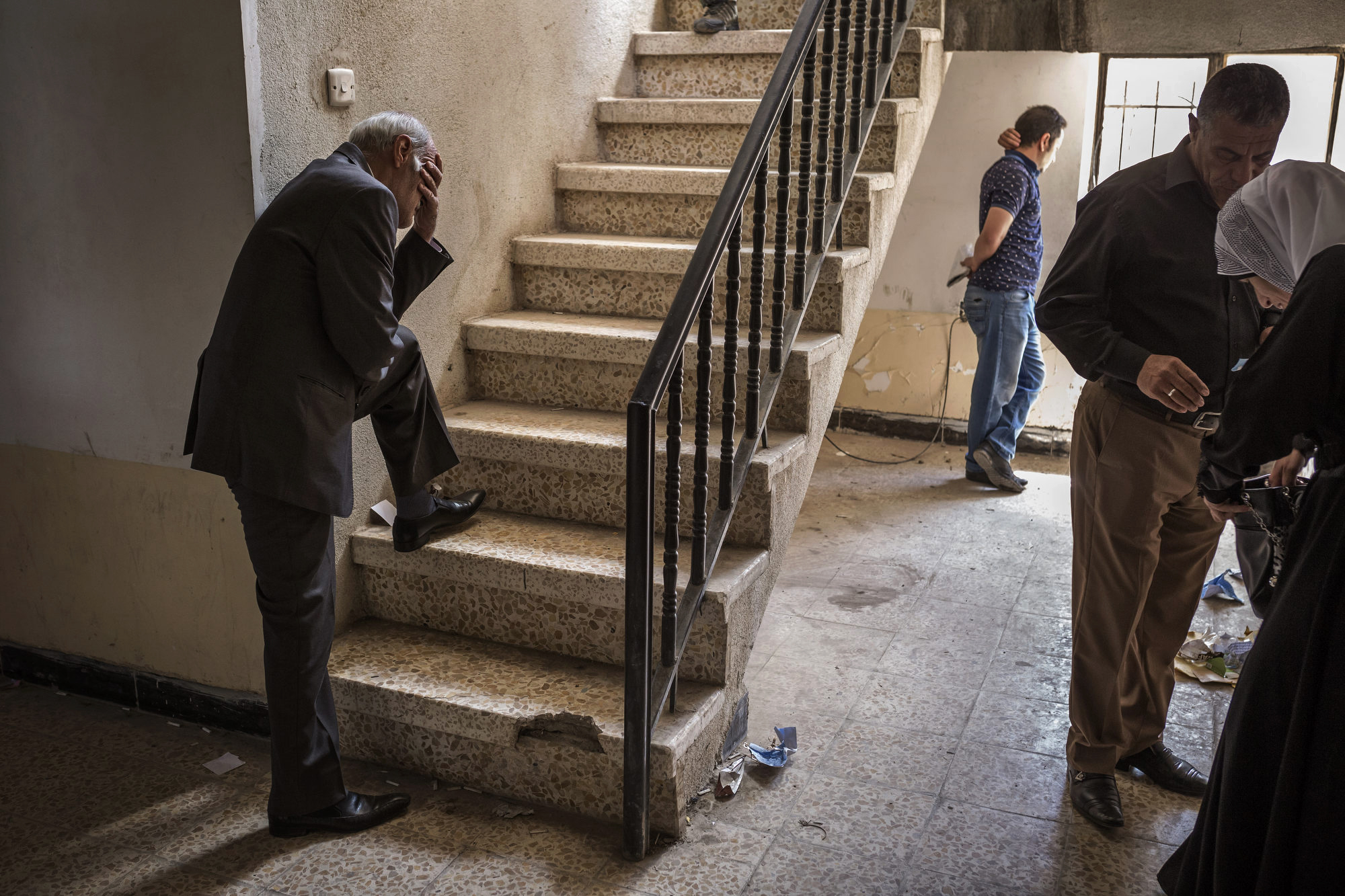  A man hangs his head in an administrative office after the liberation of East Mosul. 