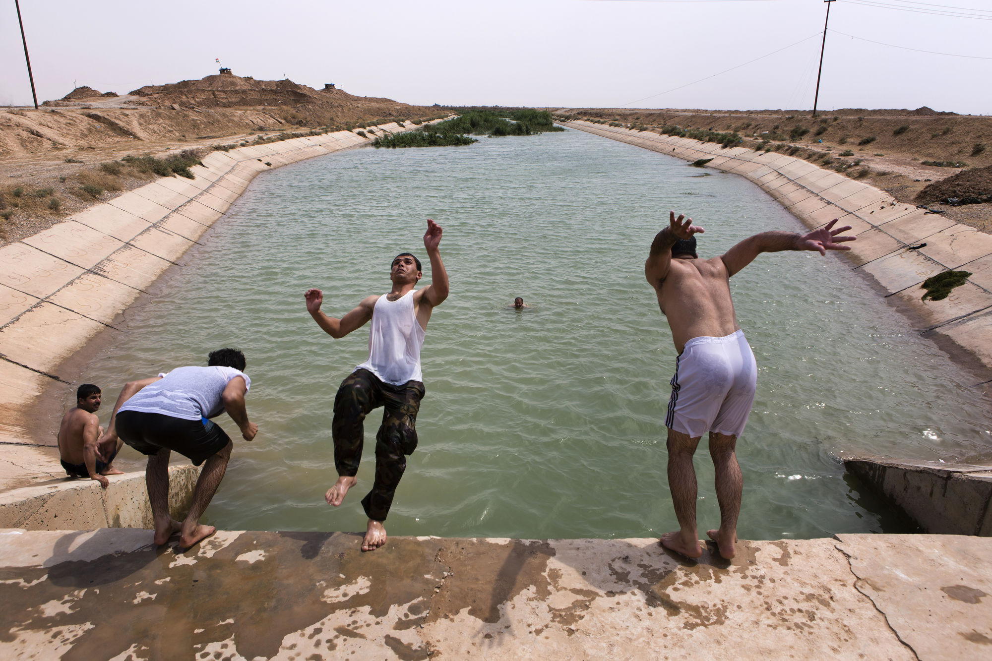  Peshmerga swim in an irrigation canal at a front line position. 