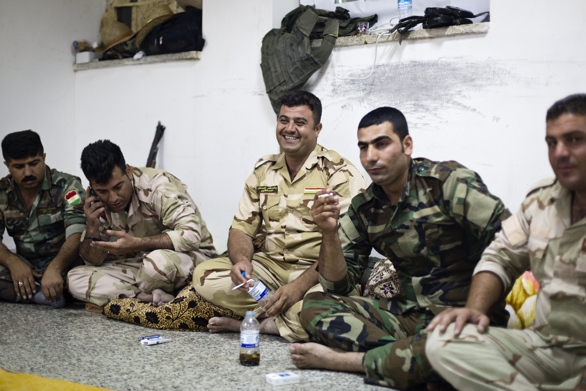  Peshmerga smoke, sing and play with their phones in the evening. 