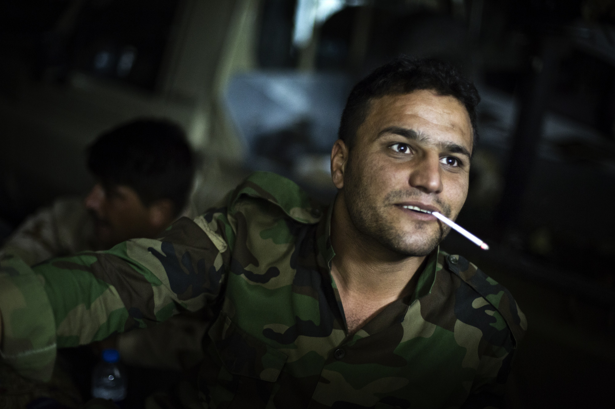  A soldier gestures to a friend during downtime. 