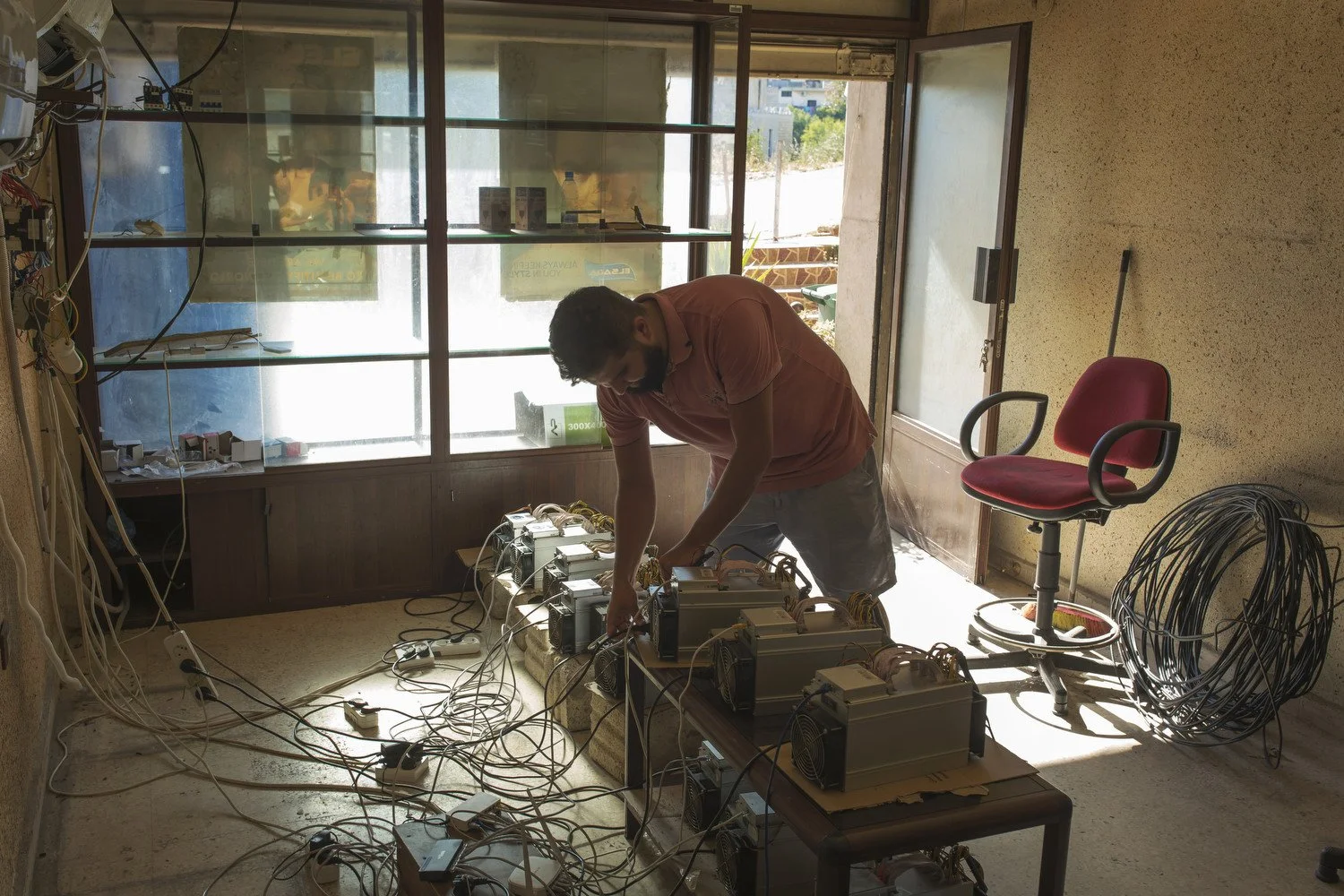  Ahmed Abu Daher checks on some of his mining machines. 