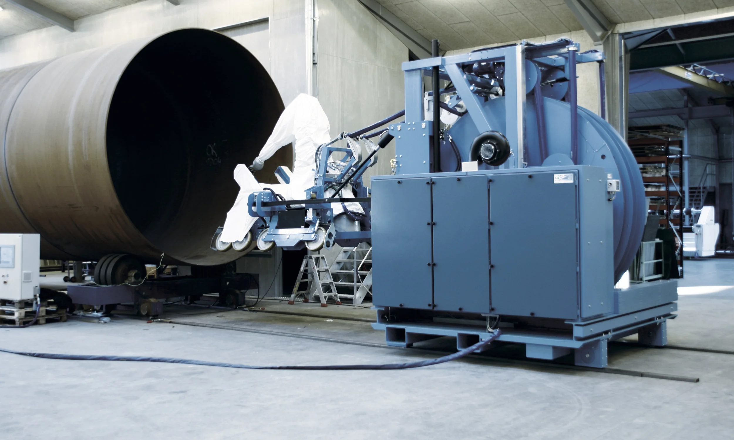 WIND TURBINE TOWER ROBOT Robot system developed to coat the inside surface of wind turbine towers.