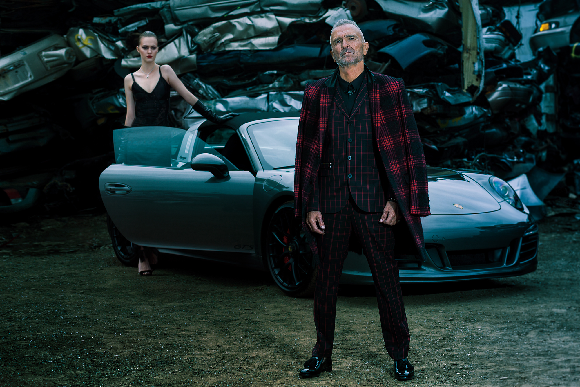Car PORSCHE 911 TARGA 4 GTS. On Katrina: Dress LOUIS VUITTON. Necklace GUCCI. Shoes JIMMY CHOO. On Monty: Suit, shirt and coat HUGO BOSS. Shoes JIMMY CHOO.