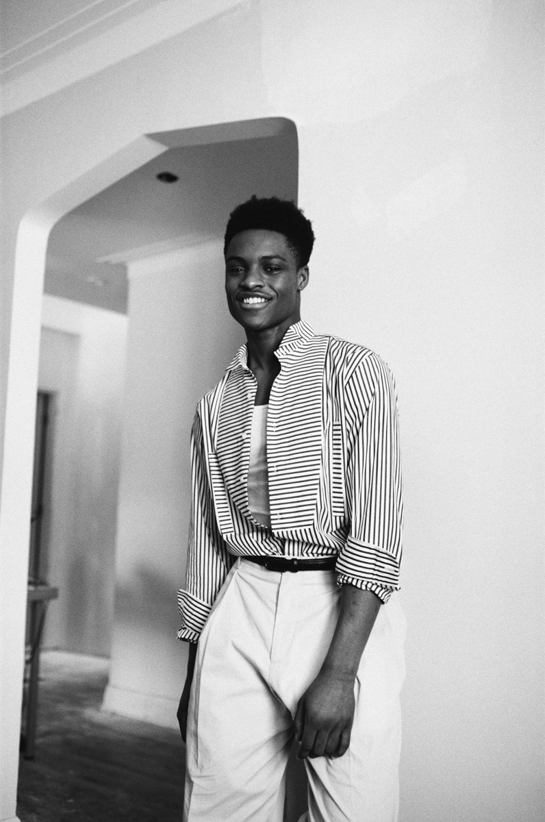 Shirt ($900) LOEWE at HOLT RENFREW. Tank top ($95) SANDRO. Pants ($135) COS. Belt ($165) PHILIPPE DUBUC.