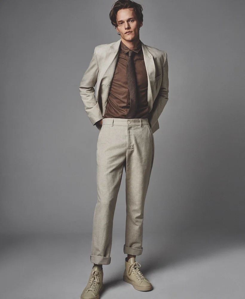 Trousers ($200), blazer ($450), and shirt ($200) KRAMER & STOUDT. Tie ($40) SELECTED HOMME.